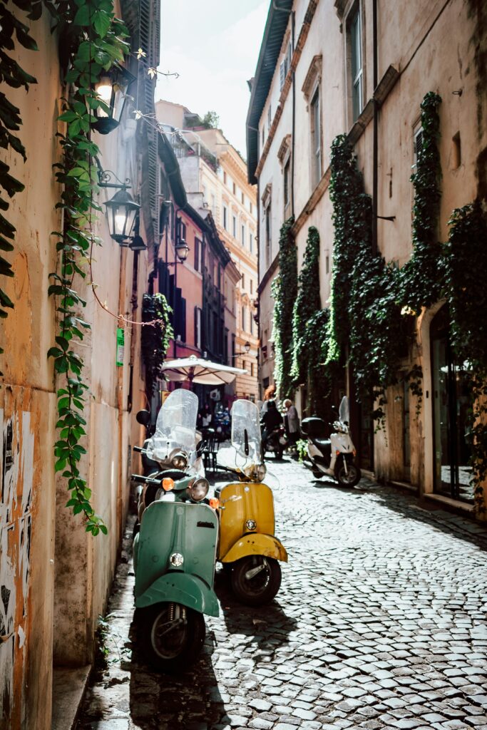 Vespa motorcycle for hire in an alley in Florence